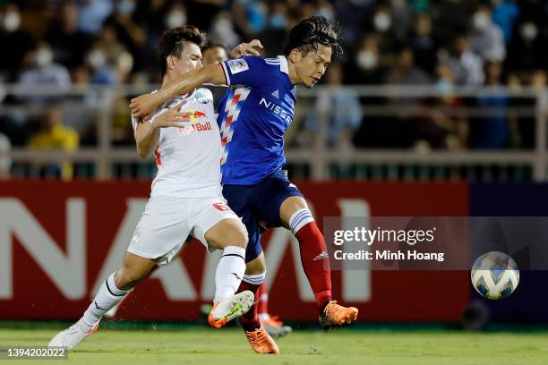 Tomoki Iwata of Yokohama F. Marinos defends a goal attempt by Luong Xuan Truong of Hoang Anh Gia Lai during the second half of the AFC Champions...