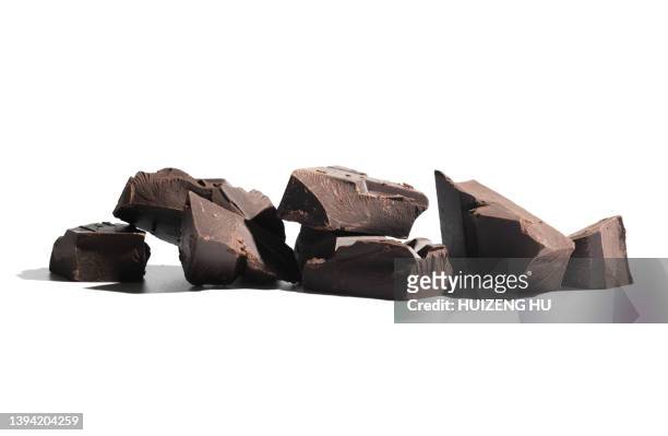 dark chocolate pieces on white background - chocolate pieces stock-fotos und bilder