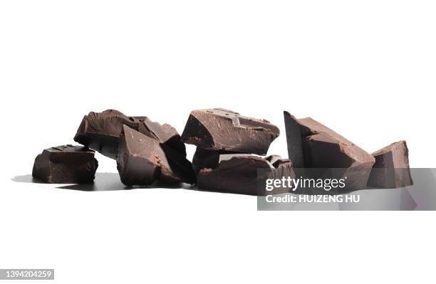 dark chocolate pieces on white background - chocolate explosion stock pictures, royalty-free photos & images