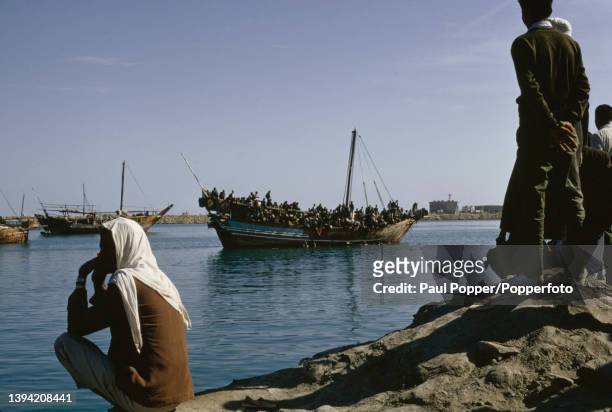 Dhow crowded with Muslim pilgrims prepares to depart from the port of Doha, the capital city of Qatar on the Arabian Peninsula, bound for Jeddah in...
