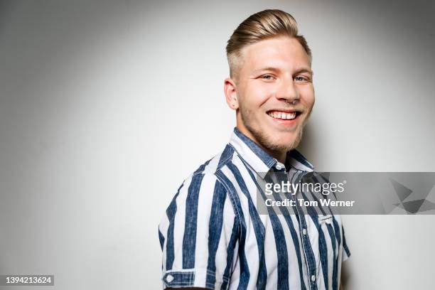 portrait of smiling blond man turned to side - striped shirt stock pictures, royalty-free photos & images