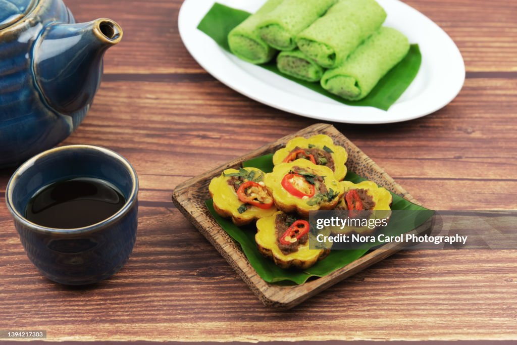 Malaysian traditional savory cake on a wood plate - Kuih Cara Berlauk, Malaysian savory pancake