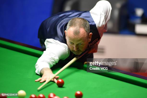 Mark Williams of Wales plays a shot during the semi-final match against Judd Trump of England on day 13 of the Betfred World Snooker Championships...