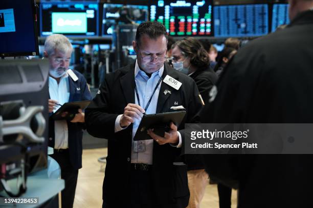 Traders work on the floor of the New York Stock Exchange on April 28, 2022 in New York City. The Dow Jones Industrial Average was up in morning...