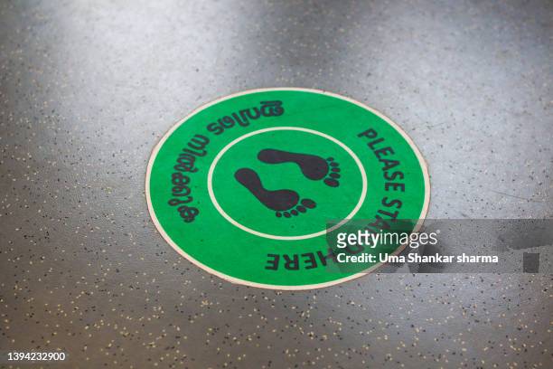 social distancing sticker on floor. - covid-19 social distancing stock pictures, royalty-free photos & images
