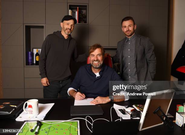 Jurgen Klopp manager of Liverpool signing a contract extension with Michael Gordon President of Fenway Sports Group and Julian Ward assistant...