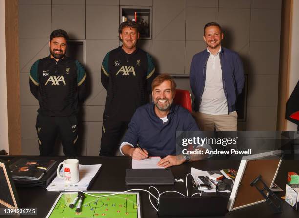 Jurgen Klopp manager of Liverpool signing a contract extension with Pepijn Lijnders assistant manager of Liverpool, Peter Krawietz assistant manager...