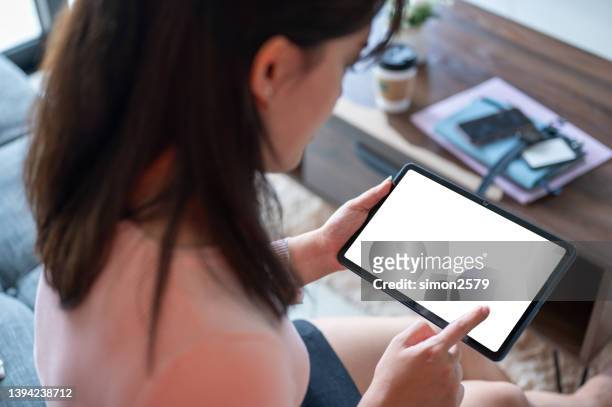 woman looking at blank digital tablet - computer screen over shoulder stock pictures, royalty-free photos & images