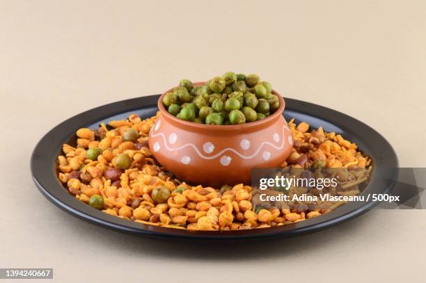 indian snack mixture and spiced fried green peas chatpata matar - matar stock pictures, royalty-free photos & images