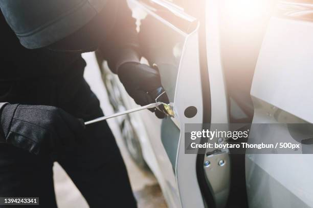 close up car thief wearing black - burglary stock pictures, royalty-free photos & images