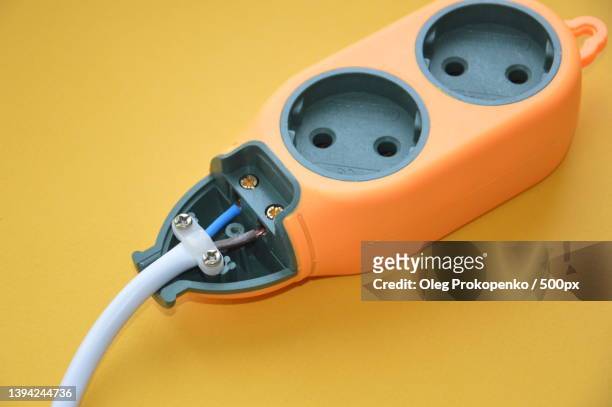 creating a plug and socket,close-up of cable against yellow background - oleg prokopenko fotografías e imágenes de stock