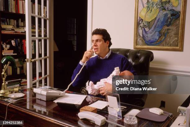 American politician Assistant Secretary of Housing & Urban Development for Community Planning & Development Andrew Cuomo talks on the telephone as he...