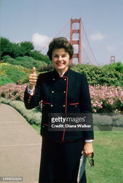 Portrait of San Francisco Mayor Dianne Feinstein as she gives a 'thumbs up' on a flower-lined path at the Presidio, San Francisco, California, May...