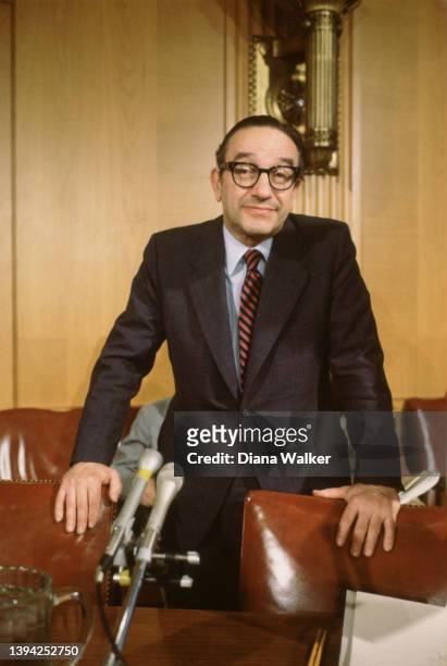 Portrait of American economist and National Commission on Social Security Reform chairman Alan Greenspan as he stands behind an array microphones on...