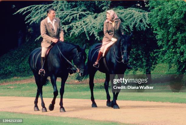 During a State Visit, US President Ronald Reagan and British monarch Queen Elizabeth II ride horses together on the grounds of Windsor Castle,...