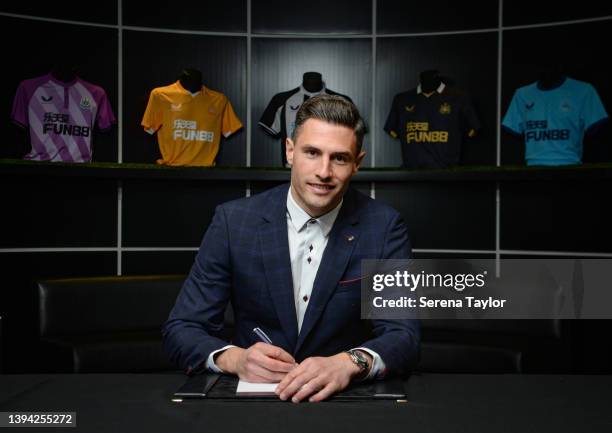 Fabian Schar poses for photos after he signs a new Newcastle United contract at St. James Park on April 28, 2022 in Newcastle upon Tyne, England.