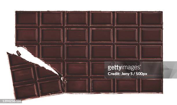 close-up of chocolate bar on white background - chocolate bar foto e immagini stock