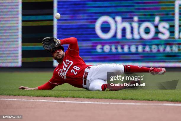 Tommy Pham of the Cincinnati Reds slides to make a catch in the first inning against the San Diego Padres at Great American Ball Park on April 28,...