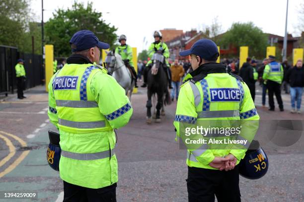 Police are seen outside the stadium prior to the Premier League match between Manchester United and Chelsea at Old Trafford on April 28, 2022 in...