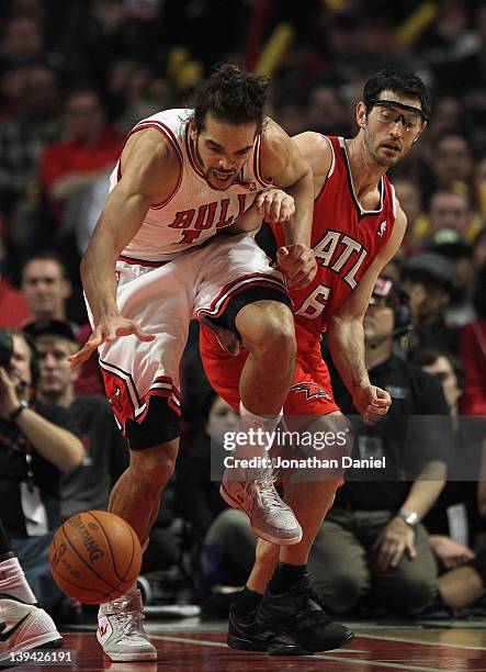 Joakim Noah of the Chicago Bulls is fouled by Kirk Hinrich of the Atlanta Hawks at the United Center on February 20, 2012 in Chicago, Illinois. The...