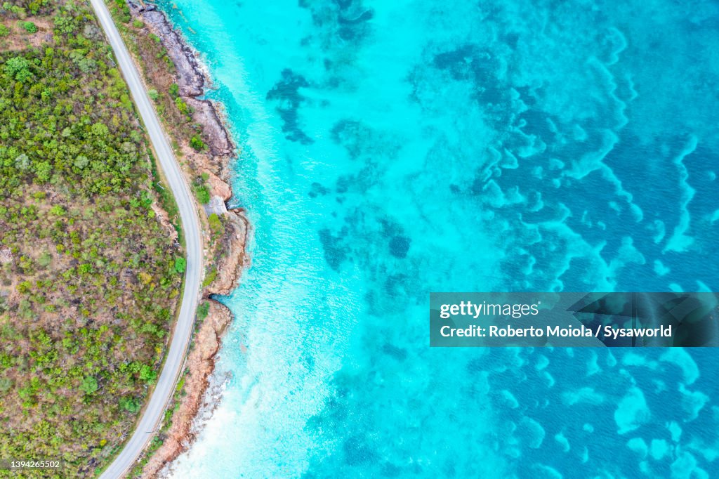 Aerial view of road beside the turquoise sea, Antigua