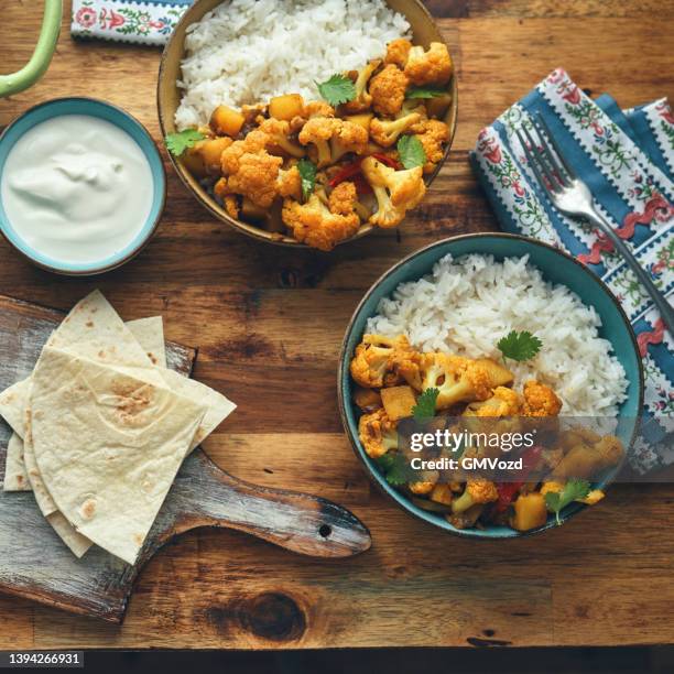 indian vegan aloo gobi dish with potatoes and cauliflower - garam masala stock pictures, royalty-free photos & images