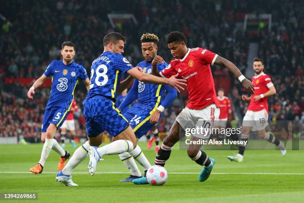 Marcus Rashford of Manchester United is challenged by Reece James and Cesar Azpilicueta of Chelsea during the Premier League match between Manchester...