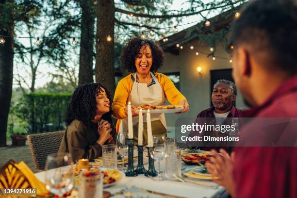 the family gathered at a festive table in the garden - happy family eating stock pictures, royalty-free photos & images