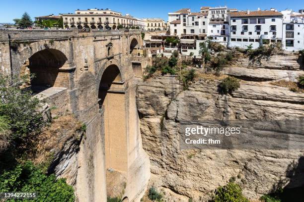 ronda and puente nuevo ("new bridge") - (andalusia/ spain) - valley side stock-fotos und bilder