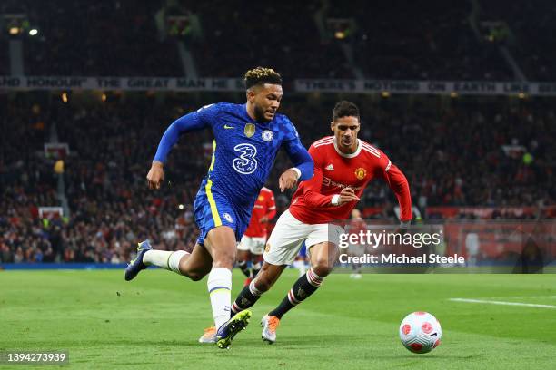 Reece James of Chelsea runs with the ball from Raphael Varane of Manchester United during the Premier League match between Manchester United and...