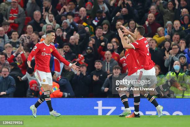 Cristiano Ronaldo of Manchester United celebrates with teammates after scoring their team's first goal during the Premier League match between...