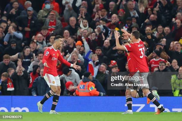 Cristiano Ronaldo of Manchester United celebrates with teammates after scoring their team's first goal during the Premier League match between...