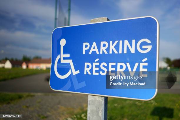 road sign indicating a location/parking reserved for disabled people - handicap parking space stock pictures, royalty-free photos & images