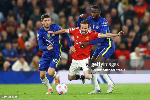 Juan Mata of Manchester United is challenged by Antonio Ruediger and Christian Pulisic of Chelsea during the Premier League match between Manchester...