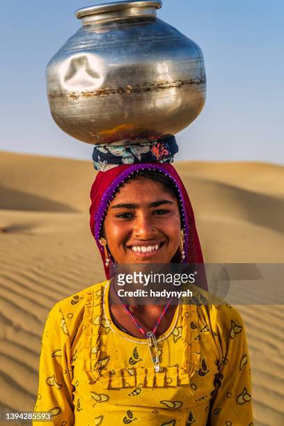 young indian girl carrying water from well, desert village, india - rajasthani youth stock pictures, royalty-free photos & images