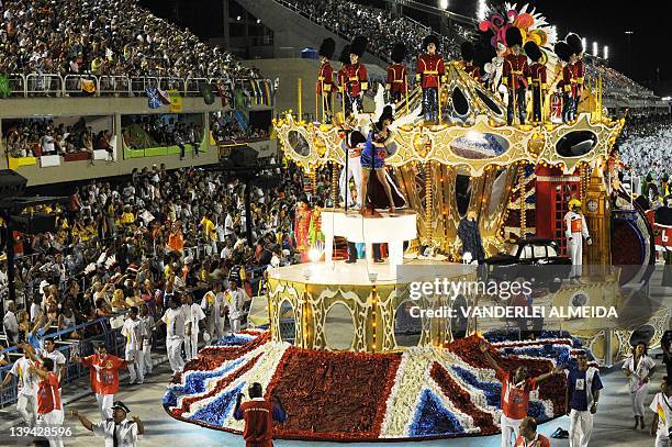 Revelers of the Uniao da Ilha samba school perform atop a float during the second night of Carnival parade at the Sambadrome in Rio de Janeiro on...