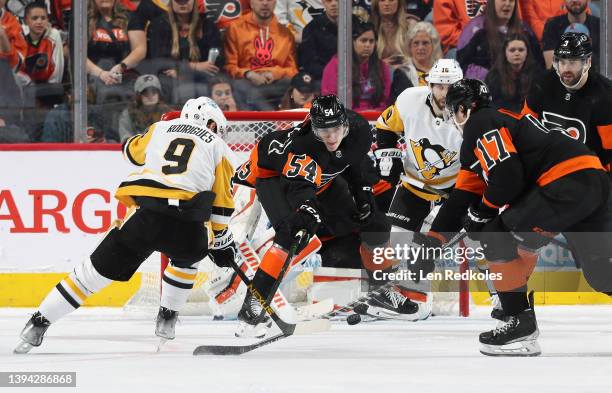 Egor Zamula, Zack MacEwen and Keith Yandle of the Philadelphia Flyers battles to clear the puck in front of goaltender Martin Jones against Evan...