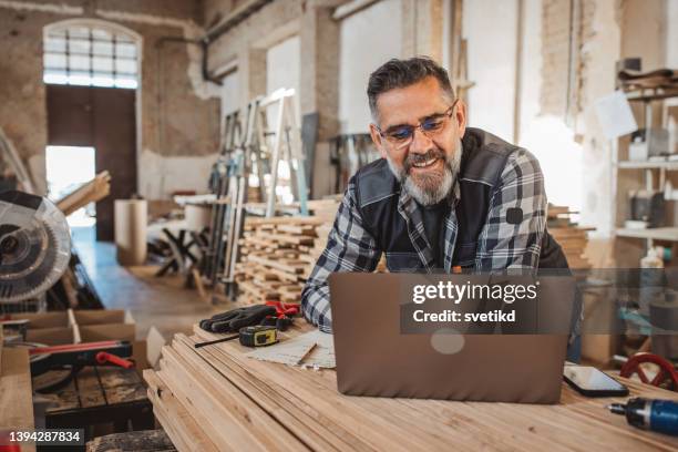 carpenter in wood workshop - mobile device on table stock pictures, royalty-free photos & images