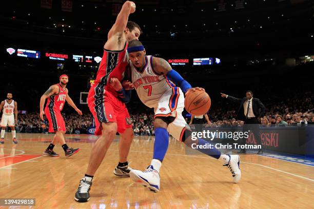 Carmelo Anthony of the New York Knicks drives against Kris Humphries of the New Jersey Nets at Madison Square Garden on February 20, 2012 in New York...