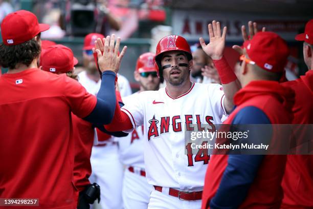 Tyler Wade of the Los Angeles Angels celebrates his run scored in by teammate Taylor Ward during the seventh inning against the Cleveland Guardians...