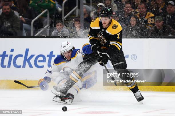 Owen Power of the Buffalo Sabres collides with Trent Frederic of the Boston Bruins during the first period at TD Garden on April 28, 2022 in Boston,...