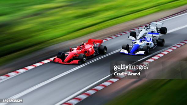 red race car leading on a race track - car racing stock pictures, royalty-free photos & images