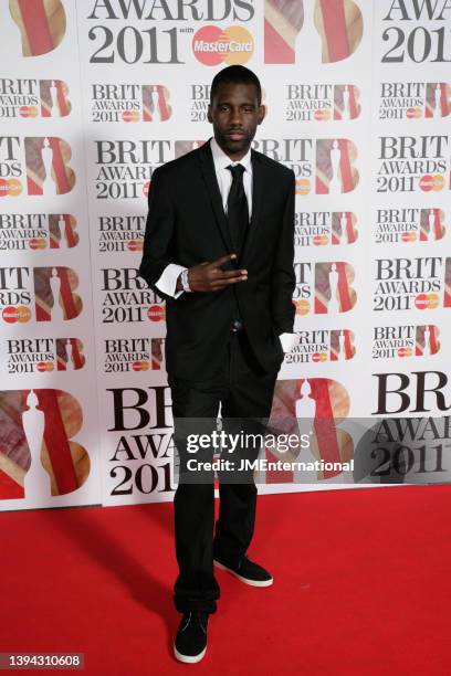 Wretch 32 attends the red carpet during The BRIT Awards 2011 at The O2 on February 15, 2011 in London, England.