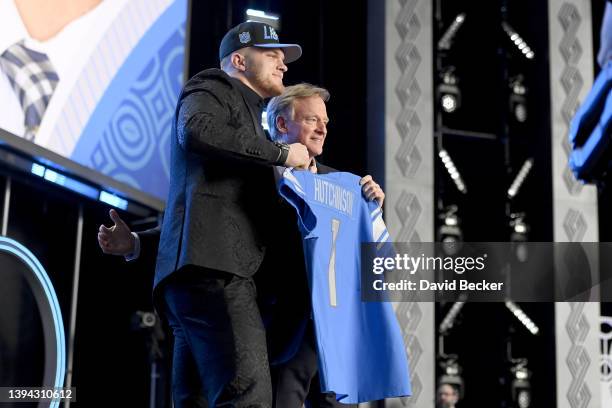 Aidan Hutchinson poses with NFL Commissioner Roger Goodell onstage after being selected second by the Detroit Lions during round one of the 2022 NFL...