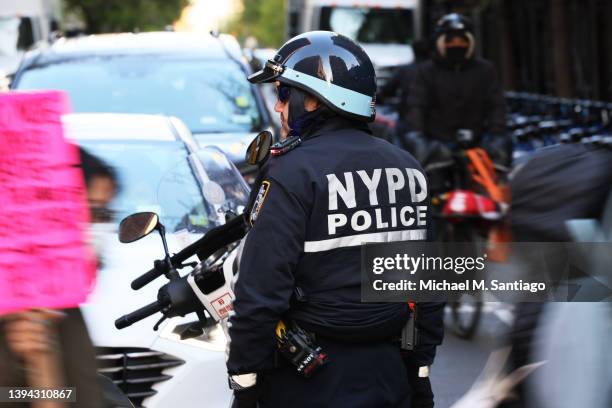 An NYPD officer blocks traffic as immigrant construction workers march as they observe Fallen Worker Day on April 28, 2022 in New York City....