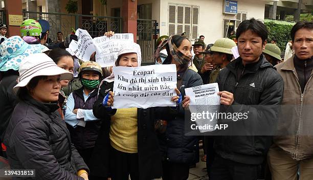 Farmers from a northern neighbouring province hold protest signs as they stage a protest over land lost outside the National Assembly office in...