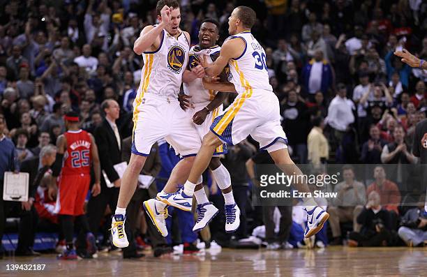 David Lee , Nate Robinson, and Stephen Curry of the Golden State Warriors celebrate after Robinson made a basket in the fourth quarter of their game...