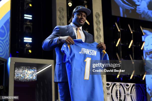 Zion Johnson poses onstage after being selected 17th by the Los Angeles Chargers during round one of the 2022 NFL Draft on April 28, 2022 in Las...