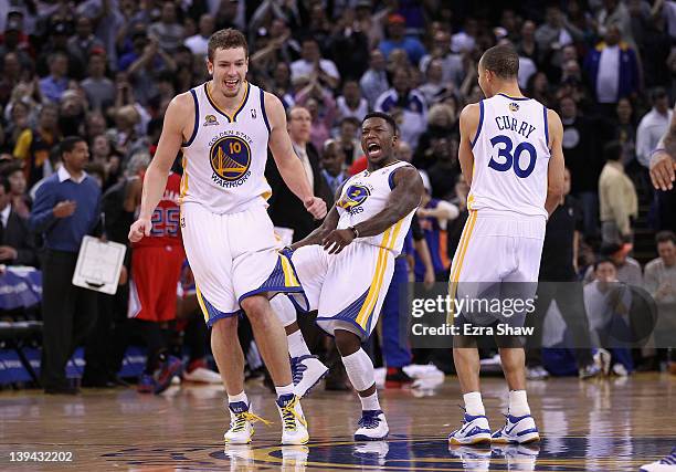 David Lee , Nate Robinson, and Stephen Curry of the Golden State Warriors celebrate after Robinson made a basket in the fourth quarter of their game...