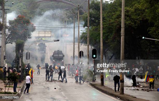 Demonstrators clash with riot police during a protest to commemorate anniversary of national strike on April 28, 2022 in Medellin, Colombia. Social...